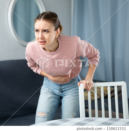 Young woman suffering from abdominal pain Young woman suffering from abdominal pain 138621531