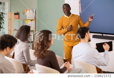 During lesson, African man teacher tells material and gives lecture 138621572