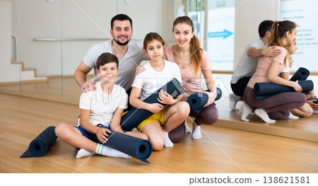 Happy family with rolled mats in gym Happy family with rolled mats in gym 138621581