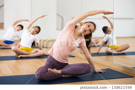 Woman with kids practicing yoga at studio 138621599