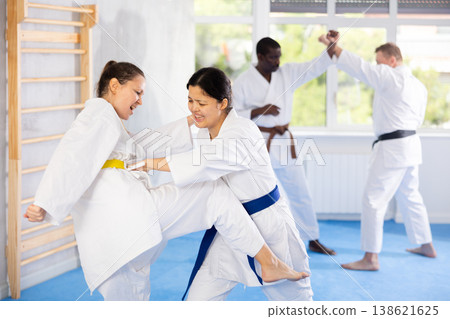 Adult and young women training karate techniques Adult and young women training karate techniques 138621625