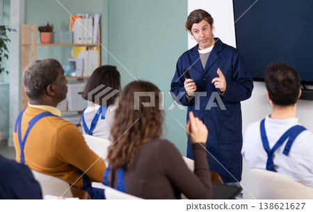 Middle aged man worker lecturer speaks to audience of listeners Middle aged man worker lecturer speaks to audience of listeners 138621627