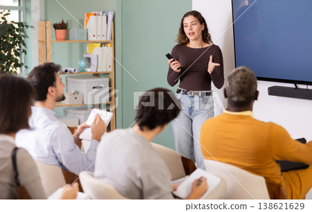 During lesson, girl teacher tells material and gives lecture During lesson, girl teacher tells material and gives lecture 138621629