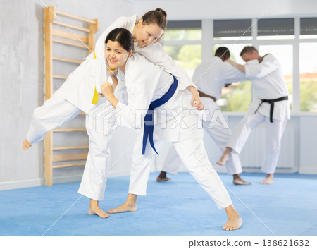 Girl tapping woman out with jiu jitsu grappling submission in gym Girl tapping woman out with jiu jitsu grappling submission in gym 138621632