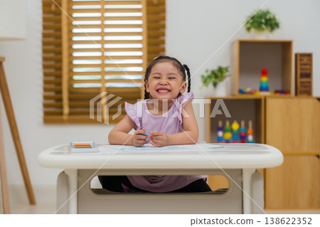 happy preschool child girl drawing and painting with colorful oil pastels on paper happy preschool child girl drawing and painting with colorful oil pastels on paper 138622352