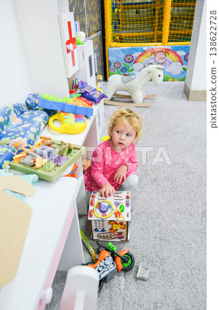 The child plays in a special playroom with different toys The child plays in a special playroom with different toys 138622728