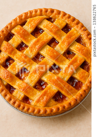 A golden, homemade apple pie woven in a lattice pattern. A golden, homemade apple pie woven in a lattice pattern. 138622765