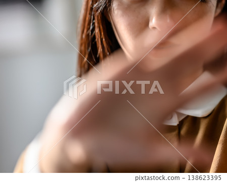 A woman waves her hand in front of her face. A woman waves her hand in front of her face. 138623395