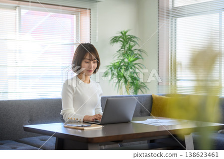 Women concentrate on PC work at home 138623461