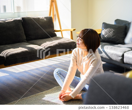A young Japanese woman relaxing in the living room A young Japanese woman relaxing in the living room 138623468