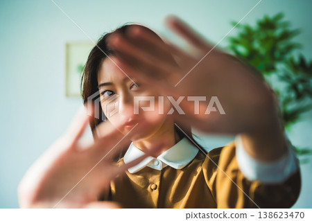 A woman rejects by raising her hand. 138623470