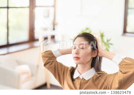 這位女士閉著眼睛，神情放鬆。 138623479