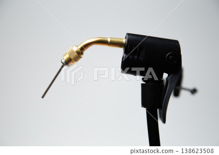 Close-up needle for inflating tires of a part of a black pump on a white background. High quality photo Close-up needle for inflating tires of a part of a black pump on a white background. High quality photo 138623508