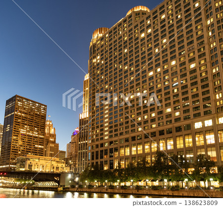 Business skyscraper at night. Skyscraper in city downtown. City architecture. Office building in business district. Modern glass building. Chicago night city. Night cityscape of Chicago skyscraper Business skyscraper at night. Skyscraper in city downtown. City architecture. Office building in business district. Modern glass building. Chicago night city. Night cityscape of Chicago skyscraper 138623809