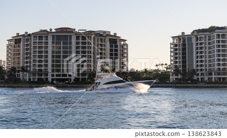 Fisher island residential building and luxury yacht boat. Motorboat passing Fisher island, Miami. Miami architecture, Florida. Luxury yacht boat at Fisher island. Summer vacation Fisher island residential building and luxury yacht boat. Motorboat passing Fisher island, Miami. Miami architecture, Florida. Luxury yacht boat at Fisher island. Summer vacation 138623843