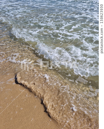 It is a sandy beach with waves rolling in. It is a sandy beach with waves rolling in. 138623930