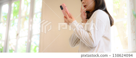 A woman watching a smartphone A woman watching a smartphone 138624094