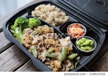 Healthy takeout bento box with mustard chicken and plenty of vegetables Healthy takeout bento box with mustard chicken and plenty of vegetables 138624382