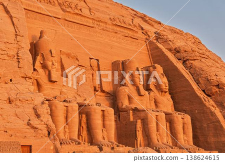 The colossal statues of the Great Temple of Abu Simbel illuminated by the morning sun—Egypt The colossal statues of the Great Temple of Abu Simbel illuminated by the morning sun—Egypt 138624615