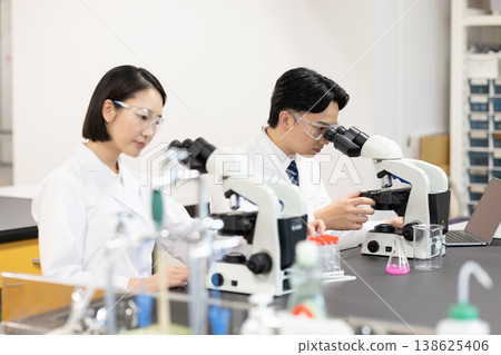 Research Image: Men and women working in a research lab. Photography cooperation: Denpa Gakuen Tokyo Electronics College. 138625406