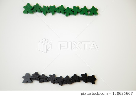 On a white background, there are green and black wooden figures of men, divided into two teams at the top and bottom with space for text. The concept of team competitions, community groups, people On a white background, there are green and black wooden figures of men, divided into two teams at the top and bottom with space for text. The concept of team competitions, community groups, people 138625607