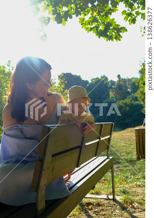 Mother and Child Enjoying a Sunny Day in the Park Mother and Child Enjoying a Sunny Day in the Park 138626377