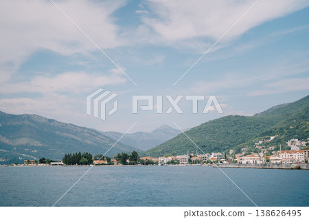 Serene Coastal Scenery. Calm Ocean View With Mountains And Village Scenes Serene Coastal Scenery. Calm Ocean View With Mountains And Village Scenes 138626495