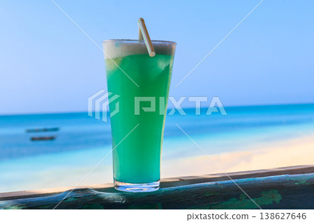Glass of Blue Hawaii cocktail by the ocean 138627646