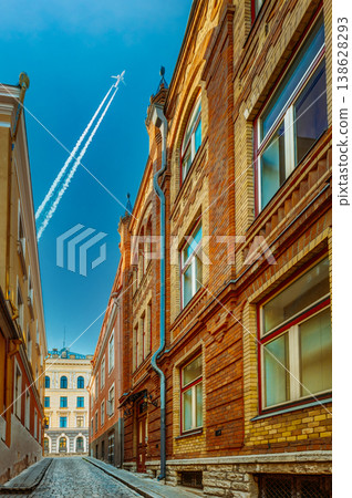 Airplane contrail over a narrow Tallinn street Airplane contrail over a narrow Tallinn street 138628293