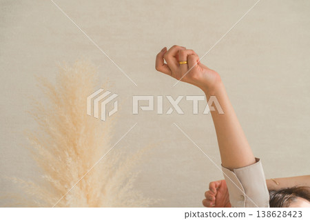 Hands of a woman stretching by the window Hands of a woman stretching by the window 138628423