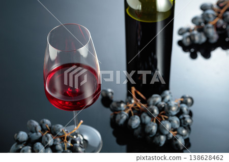 Red wine and juicy blue grapes. Red wine and juicy blue grapes. 138628462