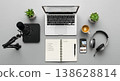 Workspace with laptop microphone headphones and plants creating productive remote work or podcast setup 138628814