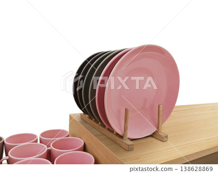 A clean dish rack sits on a wooden table against a white background. A clean dish rack sits on a wooden table against a white background. 138628869