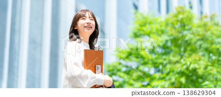 A woman/businesswoman standing in an office district (for LP/banner) A woman/businesswoman standing in an office district (for LP/banner) 138629304