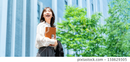 A woman/businesswoman standing in an office district (for LP/banner) 138629305