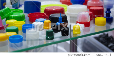 Different plastic products. Products made of multi-colored plastic. Models set of various plastic products made of plastic. Multicolored objects. Multicolored bottle caps Different plastic products. Products made of multi-colored plastic. Models set of various plastic products made of plastic. Multicolored objects. Multicolored bottle caps 138629401