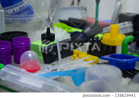 Different plastic products. Products made of multi-colored plastic. Models set of various plastic products made of plastic. Multicolored objects. 138629441
