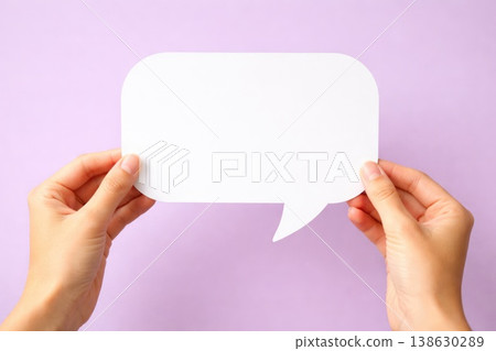 Hands holding blank speech bubble card on pastel background for text mockup 138630289