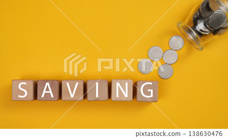 Saving money concept with coins and wooden blocks 138630476