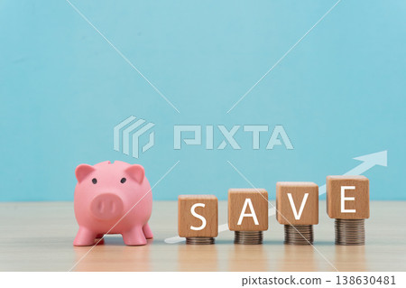 Piggy bank and savings concept with wooden blocks Piggy bank and savings concept with wooden blocks 138630481