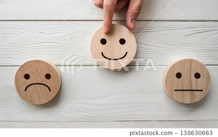 Hand Selecting Happy Face Wooden Emoji , Customer Feedback and Satisfaction Concept Hand Selecting Happy Face Wooden Emoji , Customer Feedback and Satisfaction Concept 138630663