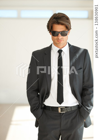 Attitude, confident and business man in office with glasses, attitude or empowered on wall background. Leader, mindset and cool male entrepreneur stylish, edgy and posing with leadership or focus Attitude, confident and business man in office with glasses, attitude or empowered on wall background. Leader, mindset and cool male entrepreneur stylish, edgy and posing with leadership or focus 138630901