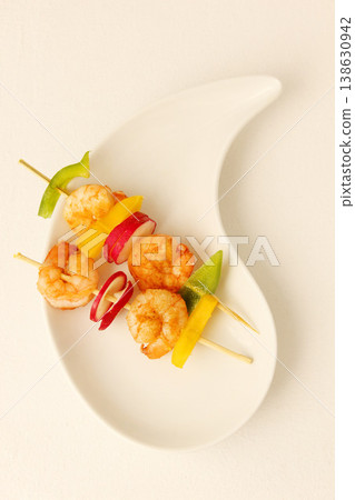 Prawn, kebab and food on plate with shrimp, vegetables and luxury menu, meat or fine dining mockup. Grilled, seafood and creative presentation of gourmet appetizer on skewers in restaurant or studio Prawn, kebab and food on plate with shrimp, vegetables and luxury menu, meat or fine dining mockup. Grilled, seafood and creative presentation of gourmet appetizer on skewers in restaurant or studio 138630942