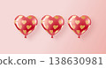 Three red and pink helium balloons in a pattern of golden hearts. 138630981