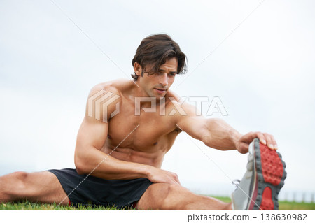 Fitness, stretching and man on grass for workout, summer sports and wellness in outdoor training. Exercise, warm up for legs and shirtless athlete on lawn for health, muscle and body care commitment. 138630982