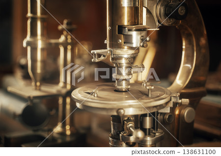 Antique Scientific Instrument Microscope in Warm Light Showing Vintage Laboratory Equipment Detail Antique Scientific Instrument Microscope in Warm Light Showing Vintage Laboratory Equipment Detail 138631100