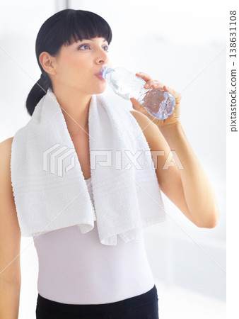 Drinking water, fitness and woman with wellness, tired and exercise with hydration, towel and sports. Person, healthy girl and athlete with liquid, aqua and workout with training, thirsty and fatigue Drinking water, fitness and woman with wellness, tired and exercise with hydration, towel and sports. Person, healthy girl and athlete with liquid, aqua and workout with training, thirsty and fatigue 138631108