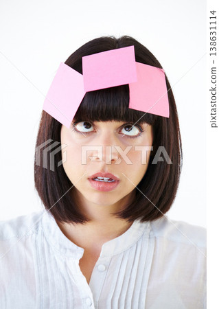 Stress, sticky note and the head of a business woman in studio isolated on a white background with a to do list. Face, thinking and confused with a young employee in doubt about a task closeup Stress, sticky note and the head of a business woman in studio isolated on a white background with a to do list. Face, thinking and confused with a young employee in doubt about a task closeup 138631114