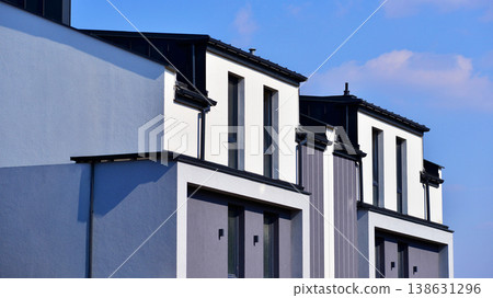 The real estate market in the suburbs. Terraced family homes in newly developed housing estate. New single family houses in a new development area. Residential homes with modern facade.  138631296