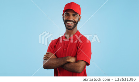 Delivery man, arms crossed in portrait and e commerce, distribution with supplier and service on blue background. Professional, supply chain and logistics worker for shipping and courier in studio Delivery man, arms crossed in portrait and e commerce, distribution with supplier and service on blue background. Professional, supply chain and logistics worker for shipping and courier in studio 138631390